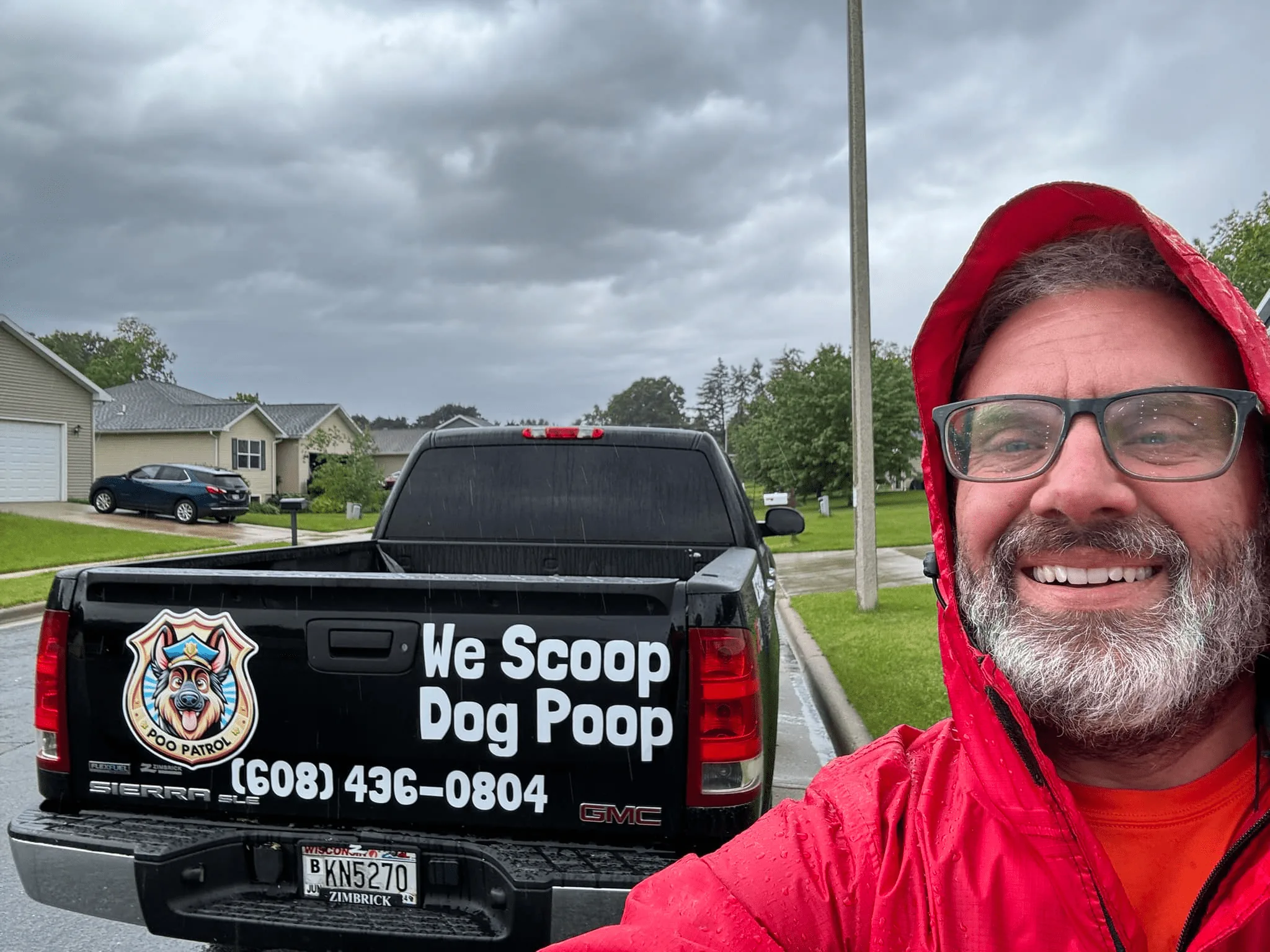 Derek, founder of Poo Patrol, by the branded truck